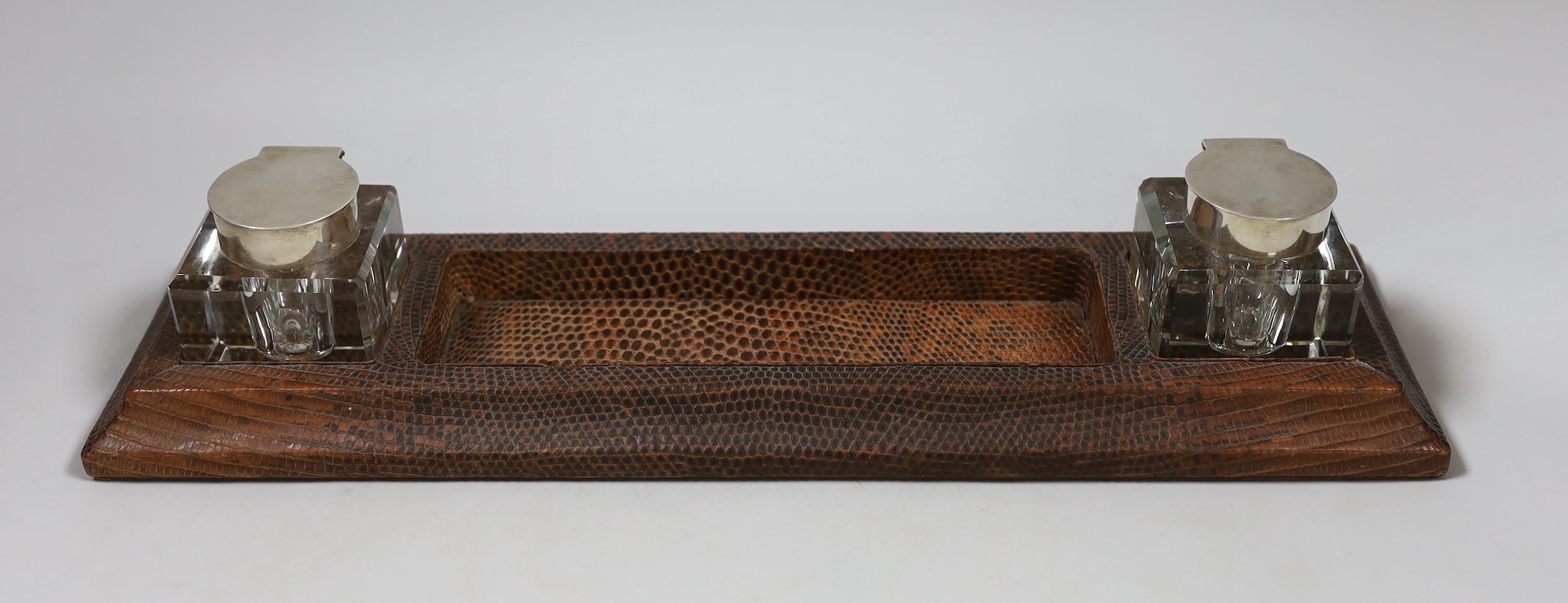 A George V Asprey & Co leather inkstand, with two mounted glass wells, Asprey & Co, London ,1934, length 38.2cm.